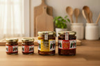 Four jars of various Mr Naga ghost pepper pickle, kitchen background