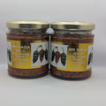 Two jars of Mr Naga Gold Green Chilies on a white background
