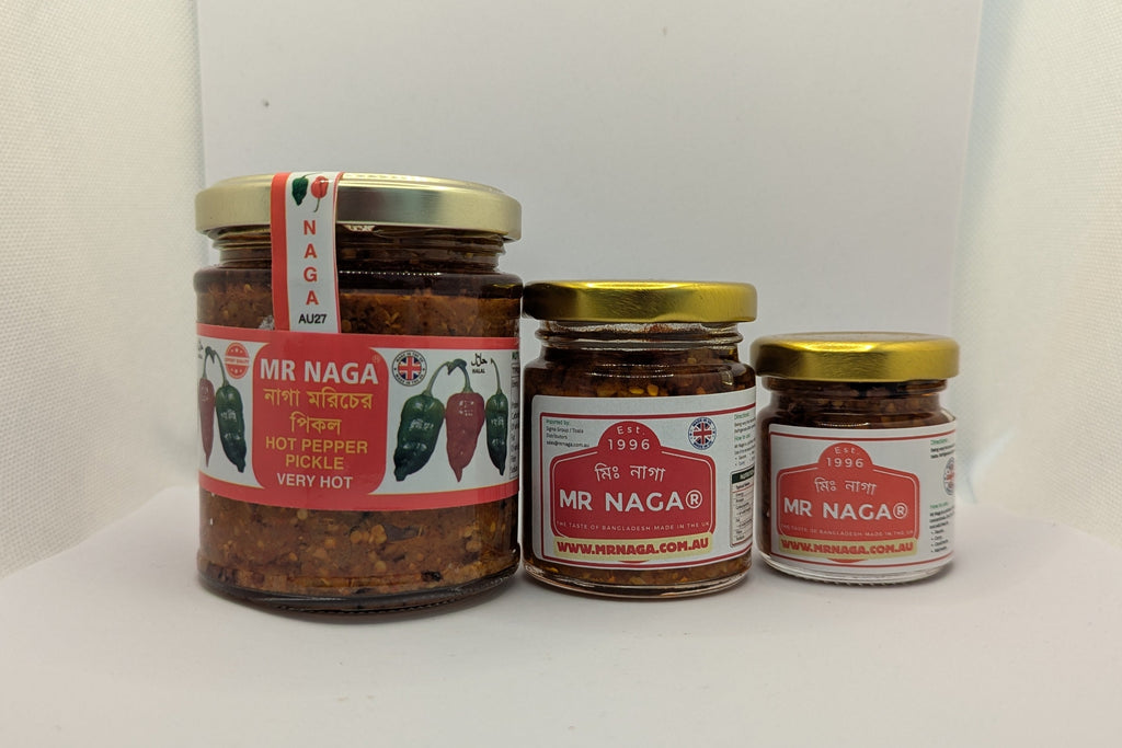 Three jars of MR NAGA chili pepper sauce on a white surface with a white background