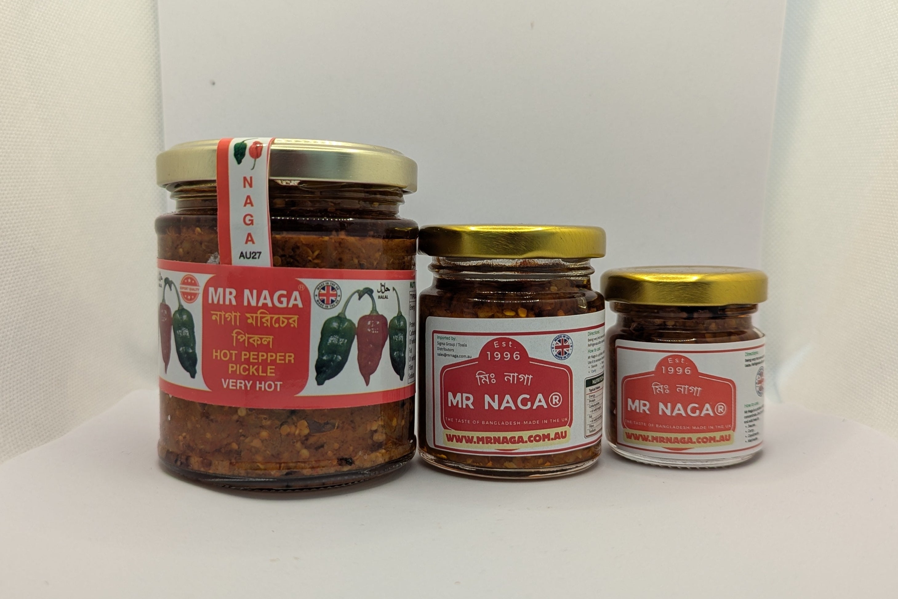 Three jars of MR NAGA chili pepper sauce on a white surface with a white background