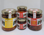 Four jars of Mr Naga hot pepper pickles on a white background