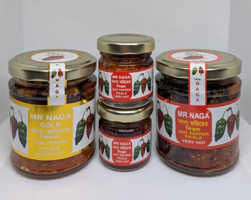 Four jars of Mr Naga hot pepper pickles on a white background