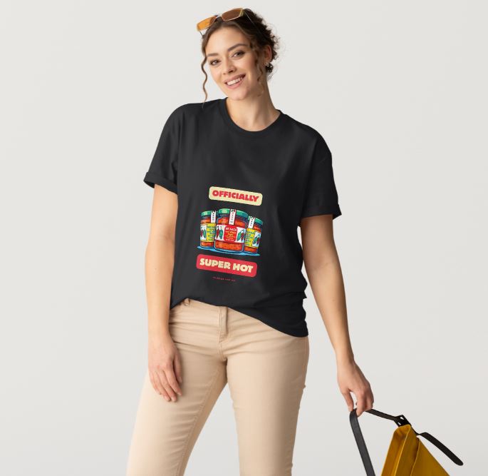 Woman wearing a black t-shirt with colorful graphic design on a plain background