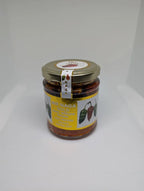 Jar of hot sauce with a label on a white background