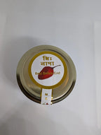 Jar lid with a label featuring a red chili and text on a white background